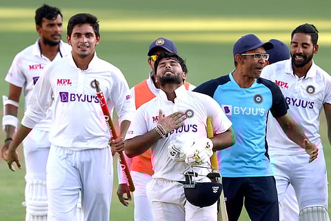 Indian players celebrate at the Gabba after defeating Australia