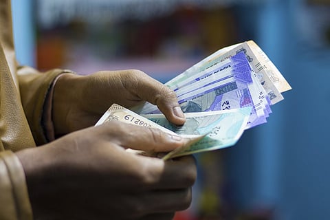 A person counting currency notes