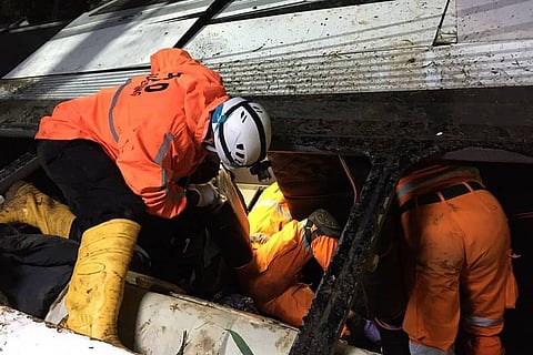 Rescue workers in Indonesia at the site of bus accident in Indonesia