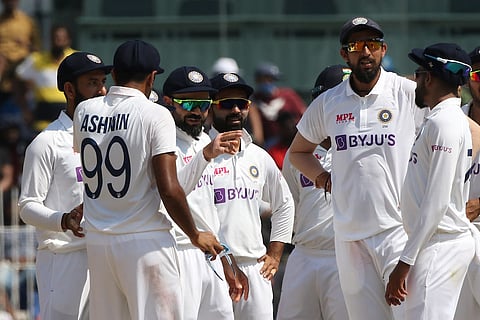 Indian players celebrate fall of a wicket