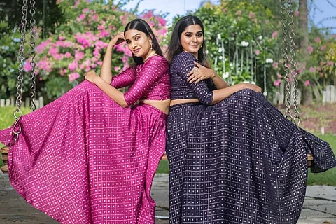 Models wearing an art silk crop top and skirt set with zari checks and buttas from Niram Studios