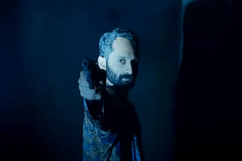 Fahad Faasil is seen holding a gun in the screengrab from the trailer of 'Irul'.