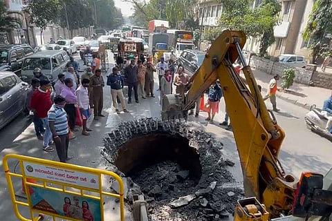 An excavator digging up the sinkhole on JC Road