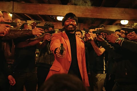 Dhanush is seen as a gangster and is surrounded by other men in the poster.