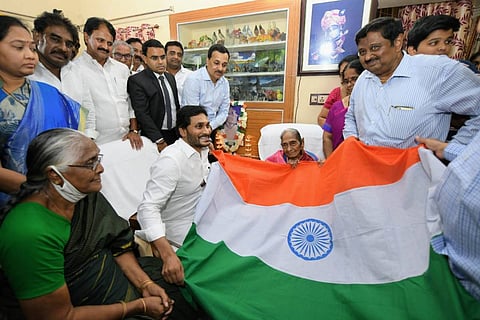 Andhra CM Jagan holding national flag while visiting Pingali Venkaiahs family