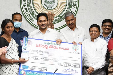 AP Chief Minister Jagan Mohan Reddy handing over Jagananna Thodu scheme cheque