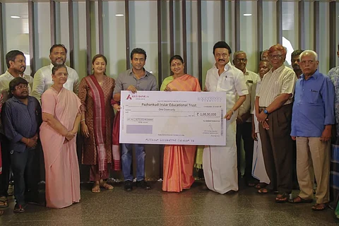 Suriya handing over the cheque to MK Stalin