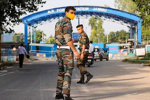 Security personnel patrol after two low intensity explosions reported in the technical area of Jammu Air Force Station in the early hours of Sunday. One caused minor damage to the roof of a building while the other exploded in an open area.