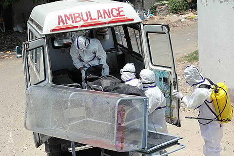 Healthcare workers with a body