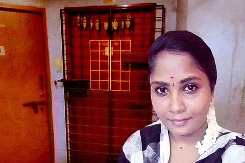 The deceased caretaker Jayapriya outside the house that caught fire