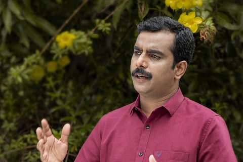 LDF Thrikkakkara candidate Dr Jo Joseph in a maroon shirt