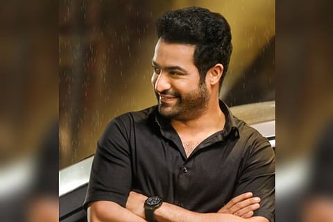 Jr NTR posing against a car