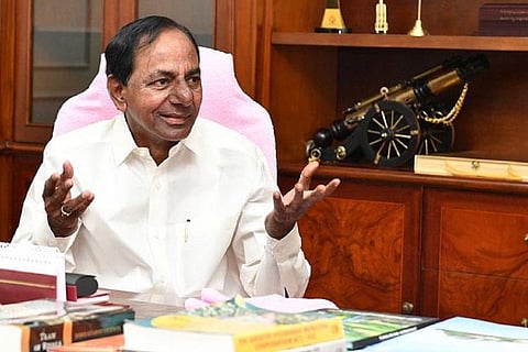 CM KCR, dressed in white, with hands outstretched