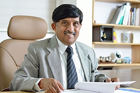 KC Ramaurthy sitting on a chair