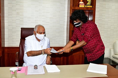 Umesh Bankar handing the letter to CM BS Yediyurappa