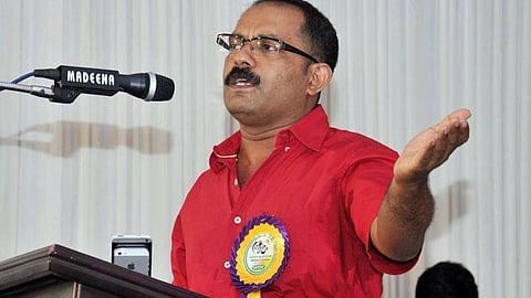 Image of KM Shaji speaking before a mic