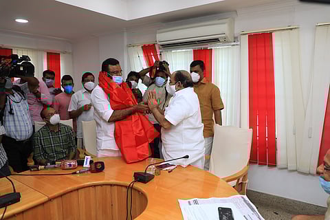 CPI(M) leader Kodiyeri Balakrishnan draping a red shawl over KP Anilkumar