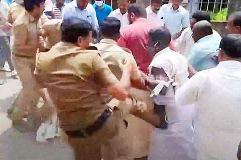 A policeman kicking KRail protestors