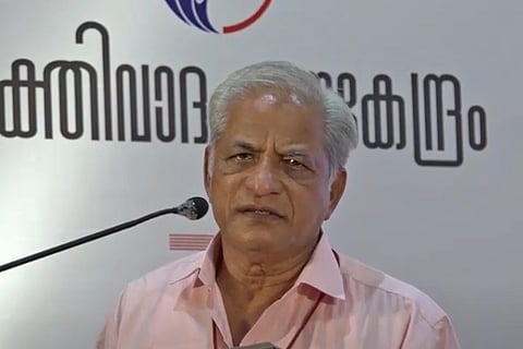 Author and rationalist KS Bhagwan in a pink shirt addressing a press meet in Kerala