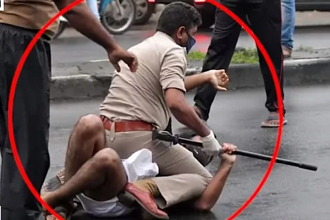 Kerala police official pins Congress worker to the ground