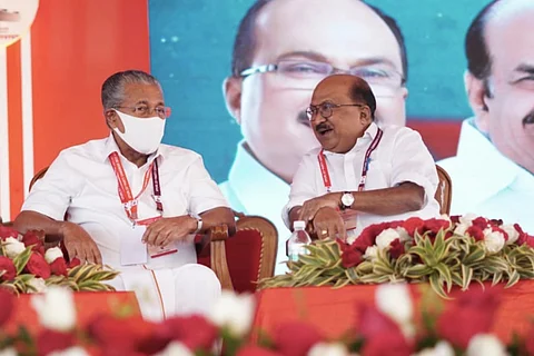 Congress leader KV Thomas sitting with Kerala CM Pinarayi Vijayan