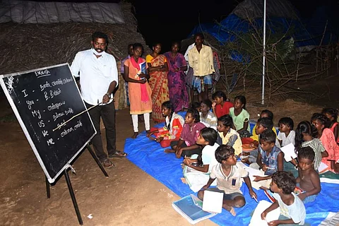 Prabhakaran taking classes for students of tribal hamlet near Kadambathur