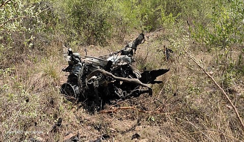 A vehicle burnt and mangled under the impact of the blast