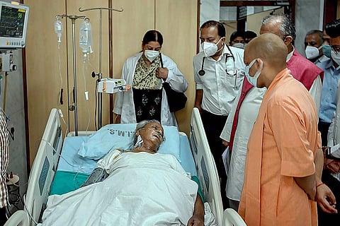 Kalyan Singh on a hospital bed with UP CM Yogi Adityanath and a group of doctors next to him