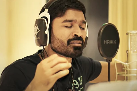 An image of Dhanush singing 'Thattan Thattan' song from 'Karnan'.