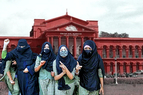 Muslim students in Hijab with the Karnataka High Court in the backdrop