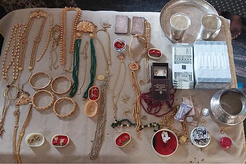 Several items of gold jewellery laid out after being seized from 18 government officials