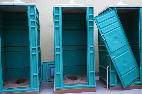 Toilets in poor condition with broken doors