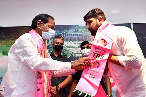 CM KCR welcoming Kaushik Reddy with a TRS party stole