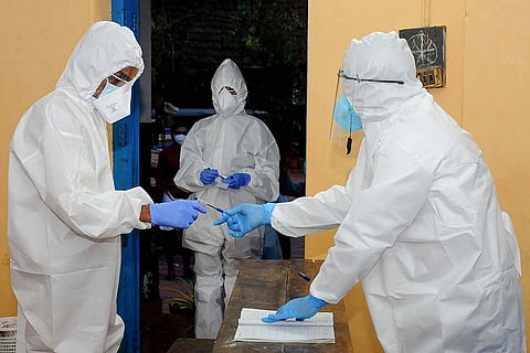 Three health workers in Kerala seen dressed in PPEs as a precaution against COVID-19