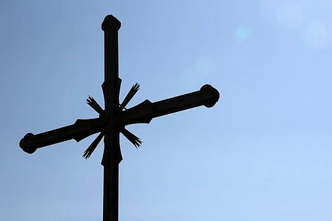 A Christian cross against a blue sky
