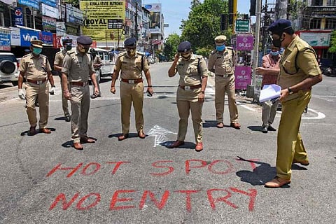 Police officials standing on road during lockdown