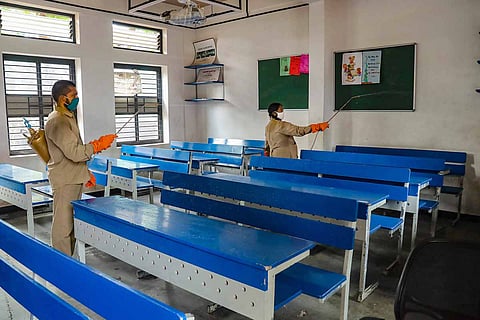 Workers sanitise the premises of an educational institution amid the coronavirus pandemic in India