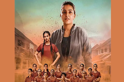 Rajisha is seen as the coach of a Kho Kho team along with its players.