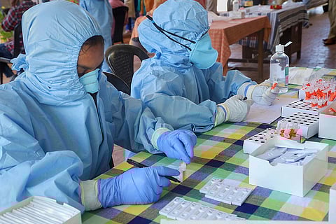 Healthcare workers take COVID-19 samples for testing