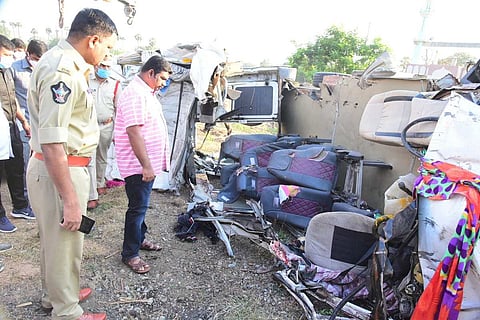 Investigating officials at the spot of the major accident in Andhra Pradesh’s Kurnool district. A tempo can be seen toppled with its roof missing.