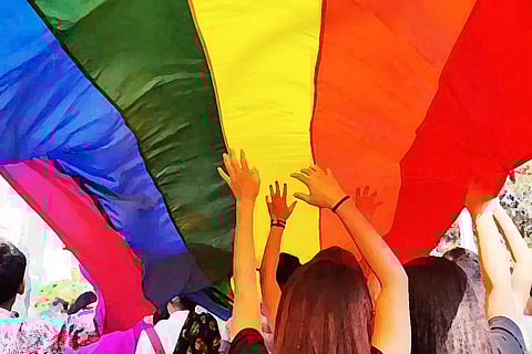 File image of people holding up the pride flag at a pride march