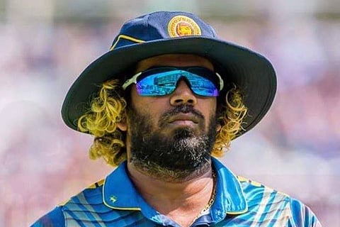 Lasith Malinga in a blue jersey wearing reflective sunglasses