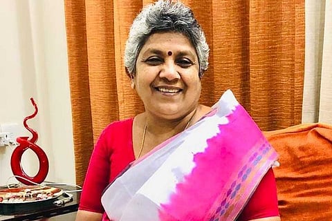 Lathika Subhash clad in a saree looking straight ahead and smiling