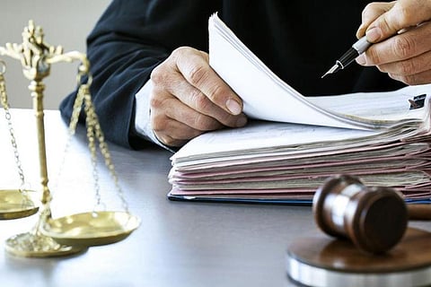 A representative image of a judge with a gavel and scales of justice seen in picture
