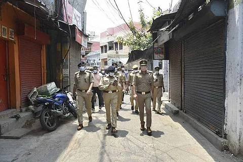 A team of Kerala police personnel inspecting a trading street