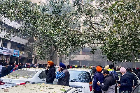 Crowd gathers at the site after an explosion at the Ludhiana district court complex