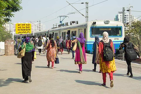 A group of women walking towards an MMTS train in Hyderabad