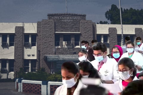 Students taking Hippocratic oath against backdrop of Madurai Medical College