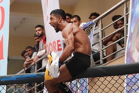 MMA champion Mahboob Khan celebrating on the cage