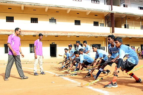 Boys with hockey sticks during training
